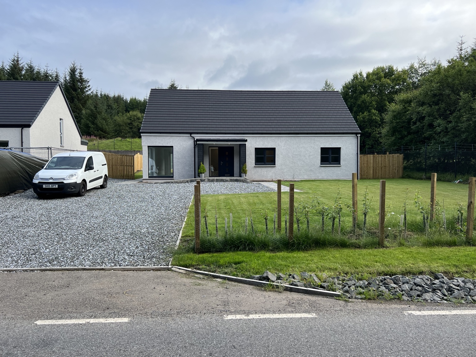 Completed single-storey home with dark detailing and landscaped frontage