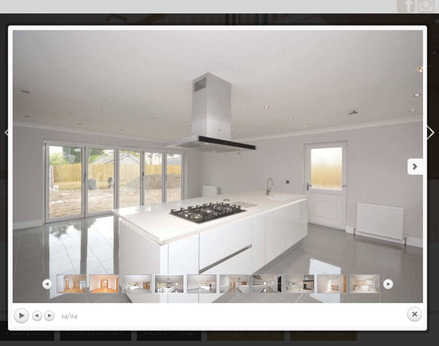 Designer kitchen with central island and garden access